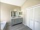 Bathroom has a double sink vanity, closet and large mirror, providing style and ample space at 8603 Primrose Dr, Kissimmee, FL 34747