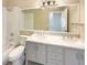 Bright bathroom with double sinks, marble counters, and a bathtub with a shower at 8603 Primrose Dr, Kissimmee, FL 34747
