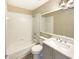 Cozy bathroom featuring bathtub/shower combination and grey vanity with white countertop at 8603 Primrose Dr, Kissimmee, FL 34747