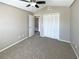 Spacious bedroom with neutral carpeting, large closet, and open doorway at 8603 Primrose Dr, Kissimmee, FL 34747