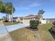 Charming single-story home featuring a well-maintained lawn and a two-car garage at 8603 Primrose Dr, Kissimmee, FL 34747