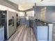 Modern kitchen with stainless steel appliances, granite countertops, a breakfast bar and gray cabinetry at 8603 Primrose Dr, Kissimmee, FL 34747