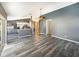 Open floor plan connects the living room, kitchen, and dining area, with sleek gray vinyl floors at 8603 Primrose Dr, Kissimmee, FL 34747