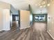 Open concept living space boasts wood look floors and pool view from large living room windows at 8603 Primrose Dr, Kissimmee, FL 34747