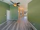 Inviting living space features modern floors, neutral paint, and natural light from the glass front door at 8603 Primrose Dr, Kissimmee, FL 34747
