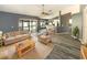 Bright, stylish living room with hardwood floors, neutral colors and sliding door access to outdoor pool at 8603 Primrose Dr, Kissimmee, FL 34747