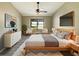 A beautifully staged main bedroom with a walk in closet and a nice view to the backyard at 8603 Primrose Dr, Kissimmee, FL 34747