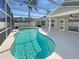 The screened-in private pool offers a cool retreat from the Florida heat with generous patio area at 8603 Primrose Dr, Kissimmee, FL 34747