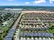 Aerial view featuring a sprawling community near a commercial center with uniformly designed homes at 9023 Shadow Mountain St, Davenport, FL 33896