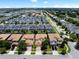 Aerial view showcases a well-planned community with uniform houses, pools, and verdant landscaping at 9023 Shadow Mountain St, Davenport, FL 33896