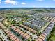 Aerial view of a residential area next to a golf course, featuring well-maintained houses and lawns at 9023 Shadow Mountain St, Davenport, FL 33896