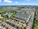 Aerial view of a large community near a golf course, featuring homes, pools, and green spaces at 9023 Shadow Mountain St, Davenport, FL 33896