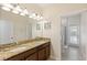 Bathroom featuring a double sink, granite counters, and a shower/tub combo with access to the pool at 9023 Shadow Mountain St, Davenport, FL 33896
