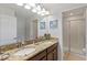 Bathroom features a double-sink vanity with granite counters and a glass-enclosed shower at 9023 Shadow Mountain St, Davenport, FL 33896