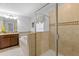 Bright bathroom boasts tiled shower, a soaking tub, and double sink vanity at 9023 Shadow Mountain St, Davenport, FL 33896