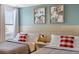 A bedroom featuring two beds with red-checkered pillows and framed Mickey and Minnie Mouse artwork at 9023 Shadow Mountain St, Davenport, FL 33896
