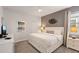 Neutral bedroom with a queen bed, side tables with lamps, and a mounted TV at 9023 Shadow Mountain St, Davenport, FL 33896