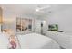 Bright bedroom featuring a queen bed, dresser with TV, and artwork at 9023 Shadow Mountain St, Davenport, FL 33896