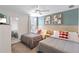 Comfortable bedroom features two beds, a ceiling fan, and charming Mickey Mouse themed decor at 9023 Shadow Mountain St, Davenport, FL 33896
