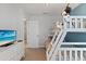 Cozy bedroom with a bunk bed, dresser, and a door to the hallway at 9023 Shadow Mountain St, Davenport, FL 33896
