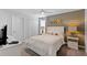 Bright bedroom with a queen bed, side tables, and a mounted TV at 9023 Shadow Mountain St, Davenport, FL 33896