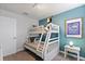 Cozy bedroom with a bunk bed, a teal accent wall, and a framed print at 9023 Shadow Mountain St, Davenport, FL 33896