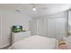 Cozy bedroom featuring a queen bed, dresser with TV, and a ceiling fan at 9023 Shadow Mountain St, Davenport, FL 33896