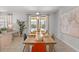 Bright dining room with a dining table set for eight, tile flooring, and views of the pool area at 9023 Shadow Mountain St, Davenport, FL 33896