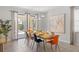Bright dining room with a dining table set for eight, tile flooring, and glass doors to the pool area at 9023 Shadow Mountain St, Davenport, FL 33896