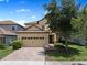 Charming two-story home with tile roof, brick driveway and attached two car garage at 9023 Shadow Mountain St, Davenport, FL 33896
