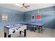 Entertaining game room with foosball and ping pong tables offers endless fun for Gathering and friends at 9023 Shadow Mountain St, Davenport, FL 33896