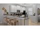 Bright kitchen featuring granite countertops, stainless steel appliances, and breakfast bar seating at 9023 Shadow Mountain St, Davenport, FL 33896