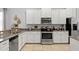 Well-equipped kitchen with stainless steel appliances, granite countertops, and ample cabinet space at 9023 Shadow Mountain St, Davenport, FL 33896