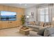 Living room featuring modern decor, tile floors, and large wall mounted television at 9023 Shadow Mountain St, Davenport, FL 33896