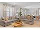 Spacious living room with tile floors, modern decor, and views into dining area at 9023 Shadow Mountain St, Davenport, FL 33896