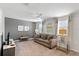 Upstairs living room with neutral decor, ceiling fan, and ample natural light at 9023 Shadow Mountain St, Davenport, FL 33896