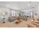 Bright living room with tile floors, neutral-toned furniture, and abundant natural light with an open floor plan at 9023 Shadow Mountain St, Davenport, FL 33896