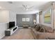 Upstairs living room with neutral decor, ceiling fan, and comfortable seating at 9023 Shadow Mountain St, Davenport, FL 33896