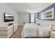 Well-lit bedroom with a king bed, flat screen TV, and contemporary furnishings at 9023 Shadow Mountain St, Davenport, FL 33896