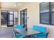 Cozy covered patio features stylish furniture and offers a perfect spot for outdoor dining and relaxation at 9023 Shadow Mountain St, Davenport, FL 33896