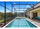 Inviting screened-in pool and spa with surrounding landscaping create a private backyard retreat for outdoor enjoyment at 9023 Shadow Mountain St, Davenport, FL 33896