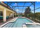 Screened-in pool and patio area with open skies, dining area, and lounging chairs at 9023 Shadow Mountain St, Davenport, FL 33896