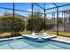 Soothing pool and spa showcases sparkling water and manicured landscaping to complete the outdoor serenity at 9023 Shadow Mountain St, Davenport, FL 33896