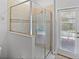 Shower featuring decorative tile and glass door with an exterior door for access to the pool at 9023 Shadow Mountain St, Davenport, FL 33896