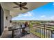 Balcony with outdoor seating overlooking a scenic landscape with railing and decorative ceiling fan at 111 E Monument Ave # 705, Kissimmee, FL 34741
