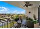 Relaxing condo balcony featuring a stylish fan, a table with seating, and serene water views at 111 E Monument Ave # 705, Kissimmee, FL 34741