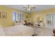 Bright and open yellow bedroom with a view, dual vanities, and tile flooring at 111 E Monument Ave # 705, Kissimmee, FL 34741