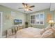 Comfortable bedroom featuring light green walls, bright window, and a charming dresser at 111 E Monument Ave # 705, Kissimmee, FL 34741