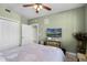 Cozy bedroom with a plush bed, ceiling fan, and soft, natural light at 111 E Monument Ave # 705, Kissimmee, FL 34741