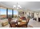 Charming dining area with a bay window, seating for four, and a modern chandelier at 111 E Monument Ave # 705, Kissimmee, FL 34741